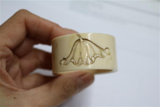 An ivory brise fan and an ivory Art Nouveau serviette ring